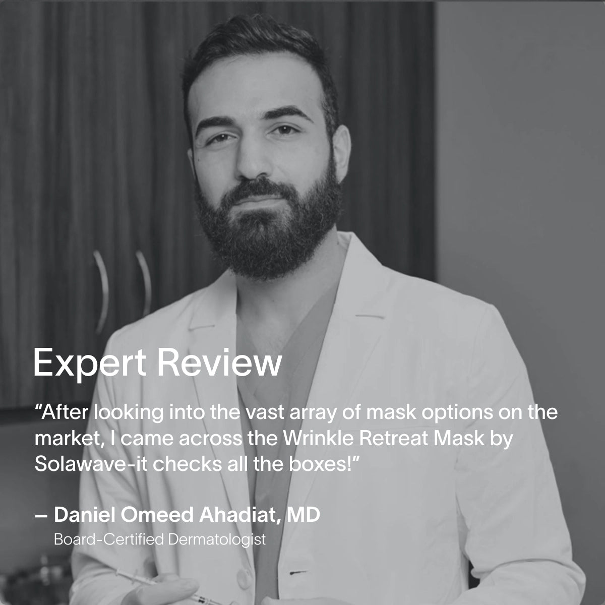 A bearded man in a white coat holds a tube, smiling slightly at the camera. Overlaid text praises Solawaves Wrinkle Retreat Face Mask & LightBoost Serum Kit, which features red light therapy and is endorsed by board-certified dermatologist Daniel Omeed Ahadiat, MD.