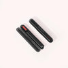 On a light background, three sleek black handheld devices with rounded edges are stacked, each featuring a glowing red strip and the SOLAWAVE text, suggesting their Radiant Renewal Skincare Wand Replacement Carrying Case capabilities.